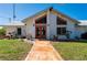Inviting front exterior showcasing walkway, double doors, and well-maintained landscaping at 29175 River Dr, Punta Gorda, FL 33982