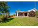 Home exterior showing spacious yard with pergola covered patio at 29175 River Dr, Punta Gorda, FL 33982
