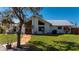 Attractive home with a metal roof, lush greenery, and a welcoming front walkway at 29175 River Dr, Punta Gorda, FL 33982