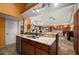 Kitchen island featuring a marble countertop, with a sink and stainless steel dishwasher at 29175 River Dr, Punta Gorda, FL 33982