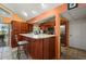 Eat-in kitchen featuring a center island with stone counters, wood cabinets and stainless steel appliances at 29175 River Dr, Punta Gorda, FL 33982