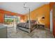 Bright main bedroom features a bed, sliding glass door, and ample natural light at 29175 River Dr, Punta Gorda, FL 33982