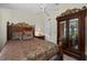 Luxurious main bedroom with ornate furniture, ceiling fan, and sliding glass doors leading to an outdoor space at 29175 River Dr, Punta Gorda, FL 33982