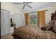 Comfortable bedroom featuring a decorative bed frame, closet, and sliding glass door access to the backyard at 29175 River Dr, Punta Gorda, FL 33982