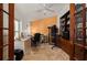 Office space featuring travertine floors, natural light, a desk, and storage at 29175 River Dr, Punta Gorda, FL 33982