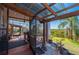 Spacious screened patio with wooden ceiling, grill, and lovely view at 29175 River Dr, Punta Gorda, FL 33982