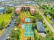 Aerial view of the community featuring a community pool and pickleball court at 3006 Caring Way # 431, Port Charlotte, FL 33952