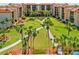 Aerial view of a community featuring palm trees, walking paths, and beautifully landscaped grounds at 3006 Caring Way # 431, Port Charlotte, FL 33952