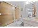 Bathroom featuring a shower and tub combo with sliding glass doors, vanity with ample counter space at 3006 Caring Way # 431, Port Charlotte, FL 33952