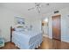 Tranquil bedroom featuring a queen bed, soft lighting, and a private door leading to the en-suite bathroom at 3006 Caring Way # 431, Port Charlotte, FL 33952