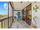 This screened lanai featuring tile flooring also has comfortable seating at 3006 Caring Way # 431, Port Charlotte, FL 33952
