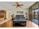 Comfortable living room with wood floors, modern furniture, and access to a screened balcony at 3006 Caring Way # 431, Port Charlotte, FL 33952