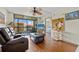 Cozy living room with wood floors, beach-themed artwork, and a comfortable recliner sofa at 3006 Caring Way # 431, Port Charlotte, FL 33952