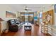 Bright living room featuring a ceiling fan, wood floors, and sliding glass doors to a balcony at 3006 Caring Way # 431, Port Charlotte, FL 33952