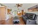 Inviting living area open to the dining area with wood floors, a ceiling fan, and natural light at 3006 Caring Way # 431, Port Charlotte, FL 33952