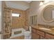 Cozy bathroom featuring a tiled shower and bath with granite vanity countertop at 3080 Belleville Ter, North Port, FL 34286