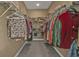 Walk-in closet with hanging clothes and organized shelves at 3080 Belleville Ter, North Port, FL 34286