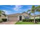 Charming single-story home featuring a well-manicured lawn, a two-car garage, and decorative palm trees at 3720 Pebble Ter, Punta Gorda, FL 33980