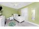 Bright bedroom with soft green walls, ceiling fan, and white accents, creating a cheerful and inviting space at 4009 Yucatan Cir, Port Charlotte, FL 33948