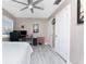 Bedroom with light grey walls, ceiling fan, white doors, and computer desk at 4009 Yucatan Cir, Port Charlotte, FL 33948