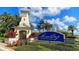 MiraBay community entrance featuring a charming lighthouse structure, colorful flowers, and lush landscaping at 435 Manns Harbor Dr, Apollo Beach, FL 33572