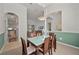 Inviting dining room featuring a glass-top table, wood chairs, and elegant lighting fixture at 4462 La France Ave, North Port, FL 34286