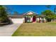 Inviting front exterior showcasing a well-manicured lawn, attached garage, and stone accents at 4462 La France Ave, North Port, FL 34286