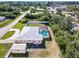 Overhead view of home with screened pool, shed, fenced yard, and metal roof close to a residential road at 4520 Knollwood Dr, Punta Gorda, FL 33982