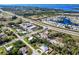 Wide aerial shot showing the home's location near a roadway and a body of water at 4520 Knollwood Dr, Punta Gorda, FL 33982