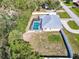 Aerial view of home showcasing a screened pool, fenced yard, and adjacent roadway at 4520 Knollwood Dr, Punta Gorda, FL 33982