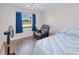Bedroom with wood floors, an upholstered chair, and a window with a view of the outdoors at 4520 Knollwood Dr, Punta Gorda, FL 33982