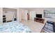Bright bedroom featuring tiled floors, walk-in closet, and view of the screened-in pool and patio area at 4520 Knollwood Dr, Punta Gorda, FL 33982