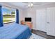 Bedroom featuring natural light, a ceiling fan, dark-colored wood floors, and a view of the front yard at 4520 Knollwood Dr, Punta Gorda, FL 33982