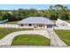 Charming single-story home with a metal roof, well-kept lawn, and a curved driveway at 4520 Knollwood Dr, Punta Gorda, FL 33982