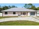 Charming single-story home featuring a metal roof, concrete driveway, and well-maintained front yard at 4520 Knollwood Dr, Punta Gorda, FL 33982