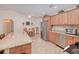 Well-lit kitchen with granite countertops, stainless steel appliances, wood cabinets and adjacent dining area at 4520 Knollwood Dr, Punta Gorda, FL 33982