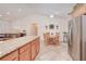 Spacious kitchen with granite counters, stainless steel refrigerator, dining area, and decorative plants at 4520 Knollwood Dr, Punta Gorda, FL 33982