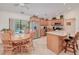 Open kitchen featuring stainless steel appliances, granite countertops, an island, and wood cabinetry at 4520 Knollwood Dr, Punta Gorda, FL 33982