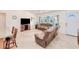 Cozy living room with tile floors, a kitchen island, and comfortable furniture at 4520 Knollwood Dr, Punta Gorda, FL 33982