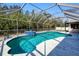 Inviting screened pool area with clear turquoise water and a calming blue tiled spa at 4520 Knollwood Dr, Punta Gorda, FL 33982