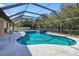 The screened-in pool area has a large pool, spa, and tropical landscaping at 4520 Knollwood Dr, Punta Gorda, FL 33982