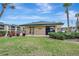 Exterior view of the community clubhouse surrounded by lush landscaping at 601 Shreve St # 13A, Punta Gorda, FL 33950