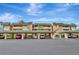 Condo building with covered parking featuring palm trees under a sunny blue sky at 601 Shreve St # 13A, Punta Gorda, FL 33950