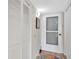 Hallway with white doors, cabinets, and a view to the front door at 601 Shreve St # 13A, Punta Gorda, FL 33950