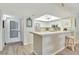 Bright kitchen with white cabinets and view to the living room at 601 Shreve St # 13A, Punta Gorda, FL 33950