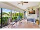 Enclosed lanai with sliding glass doors and views of the canal beyond at 601 Shreve St # 13A, Punta Gorda, FL 33950