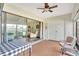 Relaxing lanai with tile flooring, sliding glass doors, and cozy seating area at 601 Shreve St # 13A, Punta Gorda, FL 33950