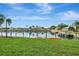 Waterfront views with docks and boats on a sunny day, with kayaks by the grassy lawn at 601 Shreve St # 13A, Punta Gorda, FL 33950