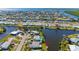 An aerial view showcases the home with a pool and canal access at 120 Buckeye Nw Ave, Port Charlotte, FL 33952