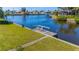A maintained backyard leads to a private dock with chairs on a serene canal at 120 Buckeye Nw Ave, Port Charlotte, FL 33952
